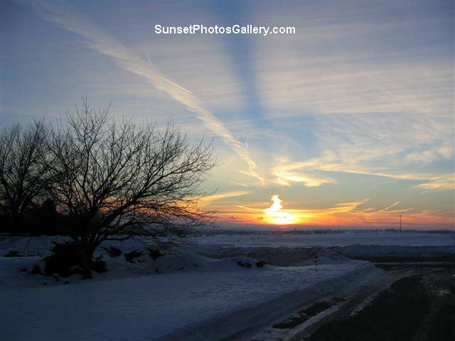 Nebraska Midwest Colorful Sunset and clouds - red, orange and blue color sunset with " beam " in sky + jet trail